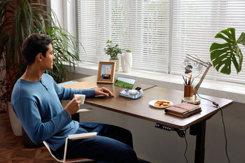 UGREEN 3-in-1 magnetic charger powering Apple devices on a home office desk