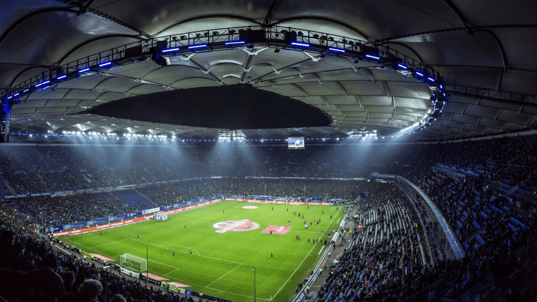 Fans fill a floodlit stadium ahead of kickoff