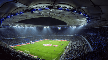 Fans fill a floodlit stadium ahead of kickoff