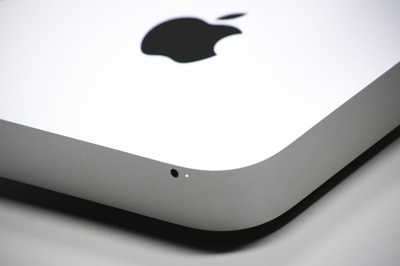 A close-up of a Mac mini with the function light on