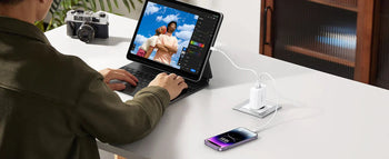 Phone charging via a fast charger while working on a tablet at a desk