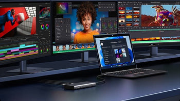 Laptop connected to multiple monitors through a USB-C hub for video editing